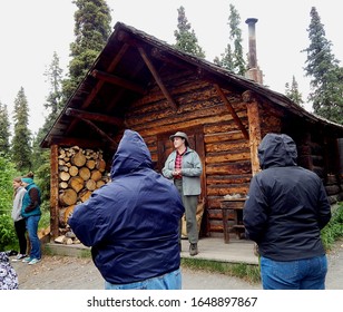 Denali NP, Alaska, USA - July 7, 2013: Female Park Ranger Giving Tourists A Cabin Tour At Denali National Park & Preserve. 
					