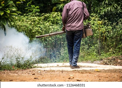 Dengue Can Be Prevented By Fumigation Mosquitoes Machine For Kill Mosquito Carrier Of Zika Virus, Spraying DDT, Insecticide So Mosquitoes Die. Prevalent Homes, Communities. Spraying Area Damp And Dark