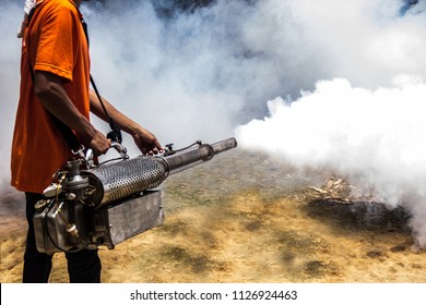 Dengue Can Be Prevented By Fumigation Mosquitoes Machine For Kill Mosquito Carrier Of Zika Virus, Spraying DDT, Insecticide So Mosquitoes Die. Prevalent Homes, Communities. Spraying Area Damp And Dark