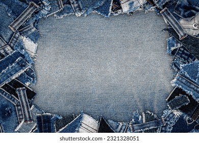 Denim blue jeans fabric frame. Ripped denim fabric. Destroyed torn denim blue jeans patches. Recycle old jeans denim pieces concept. Many fragments of jeans cloth.