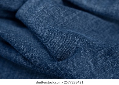 denim fabric for the production of clothing closeup, the details of a piece of sturdy denim fabric for the production of clothing, crumpled fabric