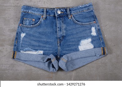 Denim female jeans shorts.Flat lay. Grey background


