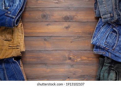 Denim Jeans On Old Wooden Background Texture Table Surface. Top View