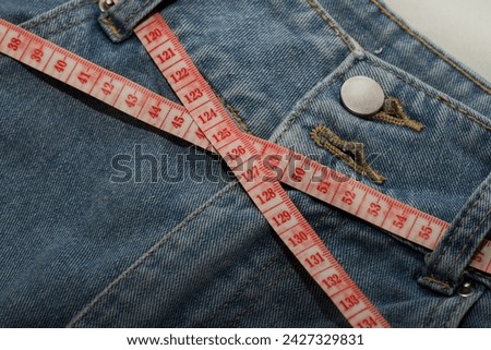 Denim with measuring tape,Symbol of discipline and focus on a diet plan for a healthy lifestyle.dieting for healty life concept.