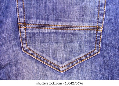 Denim. Old Faded Blue Jeans. Back Pocket. Close-up. Background. Texture.