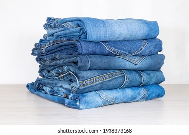 Denim Trousers Folded In A Pile On A Store Window.