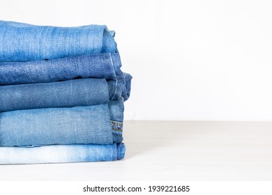 Denim Trousers Folded In A Pile On A Store Window.