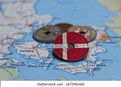 Denmark flag on the coin with heap of Danish Kroner money on the map. Concept of finance or currency or travel. - Shutterstock ID 1672981465