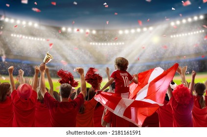 Denmark Football Supporter On Stadium. Danish Fans On Soccer Pitch Watching Team Play. Group Of Supporters With Flag And National Jersey Cheering For Denmark. Championship Game.