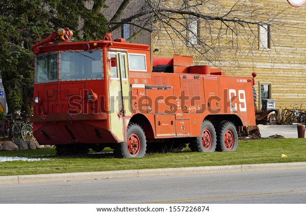 Denmark, Wisconsin / USA - November 9th, 2019:\
Vintage old US Air Force Airport Crash Rescue Fire Truck sits in\
front of Antique Shop.