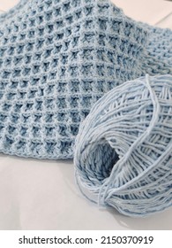 Denpasar, Bali - April 28th 2022 - Light Blue Handmade Knit Baby Blanket Made Of Soft Cotton Yarn