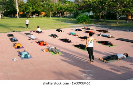 Denpasar, Bali, Indonesia - 19 September 2019: Group Of People Doing Yoga Together In A Yoga Retreat Session, And Laying Down For Meditation.