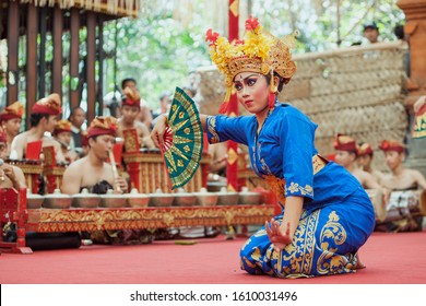 Denpasar, Bali island, Indonesia - June 23, 2016: Portrait of beautiful young Balinese woman in ethnic dancer costume, dancing traditional temple dance at art and culture festival parade.
