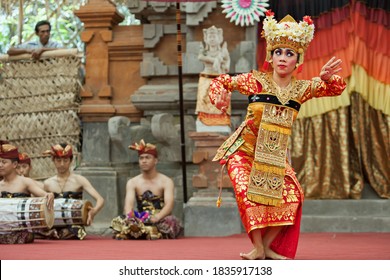 Denpasar, Bali island, Indonesia - June 23, 2016: Portrait of beautiful young Balinese woman in ethnic dancer costume, dancing traditional temple dance at art and culture festival parade.