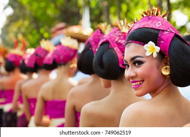 Denpasar, Bali Island, Indonesia - June 10, 2017:  Group Of Beautiful Women In Traditional Balinese Costumes Carry Religious Offering For Hindu Ceremony On Street Parade At Art And Culture Festival.