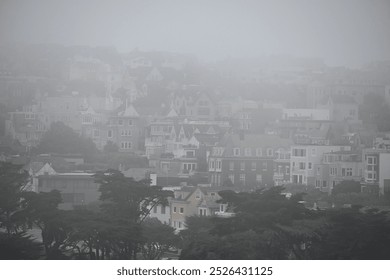 Dense fog in San Francisco, CA, USA. Richmond district from Presidio overlook. Typical weather of San Francisco during summer months - Powered by Shutterstock