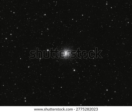 A dense globular star cluster with thousands of glowing stars is centered against the dark expanse of outer space.
