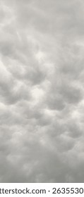 A dense, gray sky, heavy with clouds.