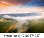 Dense morning fog enveloped the farmland from a bird