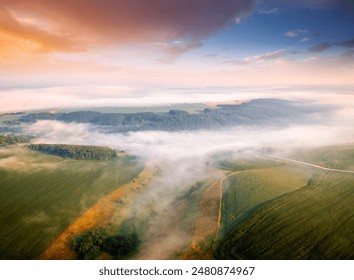 Dense morning fog enveloped the farmland from a bird's eye view. Location place Dniester canyon, Ukraine, Europe. Aerial photography, drone shot. Photo wallpaper. Discover the beauty of earth. - Powered by Shutterstock