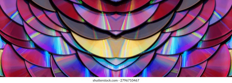a dense, overlapping pattern of compact discs with rainbow light reflection arranged like fish scales