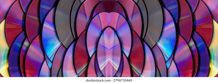 a dense, overlapping pattern of compact discs with rainbow light reflection arranged like fish scales