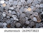 A dense pile of vintage Swiss 5 Rappen coins, mostly silver-toned with worn details, showcases Helvetia