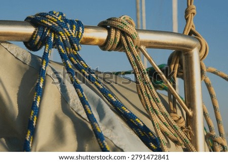 Dense sailboat rigging and line bundle near the mast showing layered knots and cordage detail.