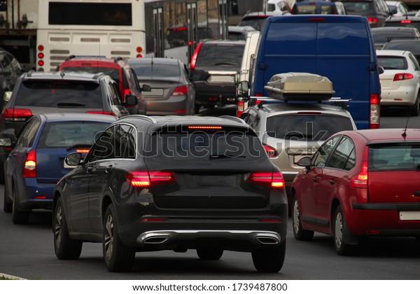 dense traffic of cars stuck in traffic with burning\
stoplights on a city road