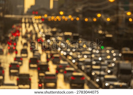 A dense traffic jam on a multi-lane highway during a rainy sunset, with blurred car lights creating a bokeh effect