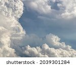 Dense white clouds contrast with grey couds 