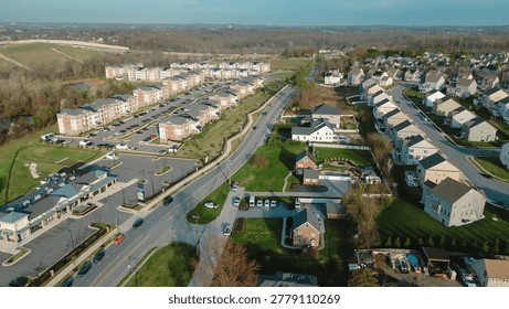 Density contrast corridor shows apartment complexes, commercial pads singlefamily homes divided by main White Marsh roadway with wooded areas open fields beyond, Maryland. USA