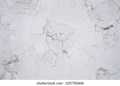  A Dent From A Blow.  Round Dents From Bumps On A White Wall. Wall Damaged By Hooligans. Cracked Wall Background. Cobweb Of Cracks On The Wall.

