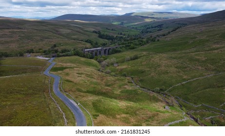 Dent, Dentdale, Cumbria, England, Britain, May 2022, Aerial View Of Minor Country Road Leading Past Dent Head Railway Viaduct With Train Crossing