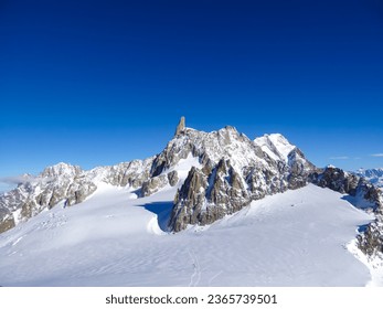 Dent du Geant (Dente del Gigante) seen from lift station Pointe Helbronner (Punta Helbronner) in Courmayeur, Aosta Valley, Italy, Europe. Snow capped Mont Blanc mountain range massif in the Alps