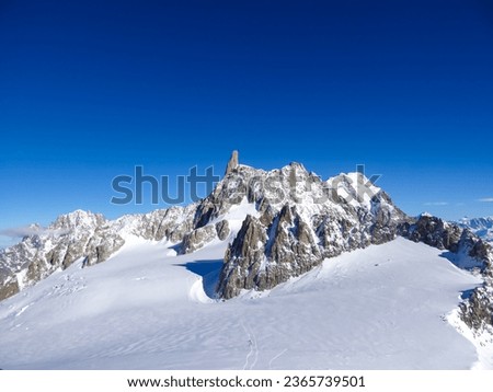 Dent du Geant (Dente del Gigante) seen from lift station Pointe Helbronner (Punta Helbronner) in Courmayeur, Aosta Valley, Italy, Europe. Snow capped Mont Blanc mountain range massif in the Alps