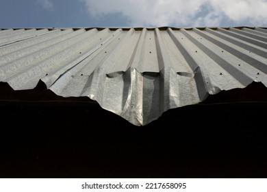 Dent On Roof. Bent Metal Profile. Roof Of Building. Architectural Details.