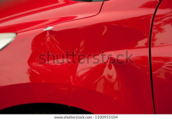 A dent\
in the right rear quarter of a european\
car