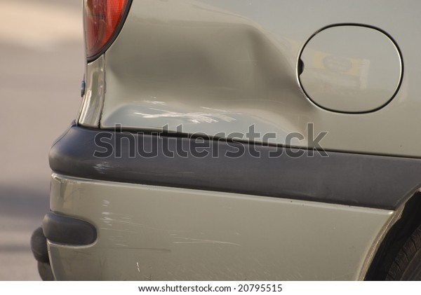 A dent\
in the right rear quarter of a european\
car