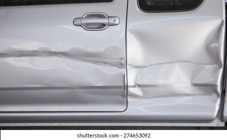 A dent in the side of a car