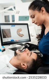 Dental 3d scanner applying process. Digital impressioning teeth of patient with a 3d digital dental scanner