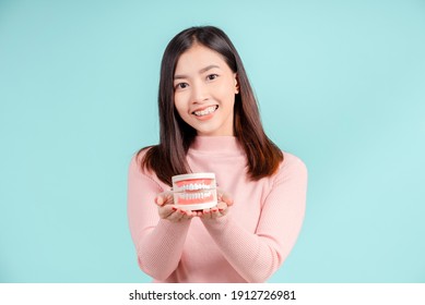 Dental Of Asian Woman With Tooth Sample And White Teeth Increase Confidence For Healthy On Blue Background Isolated Studio Shot, Happiness Teenager Smiling Facial Expression.