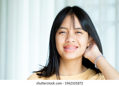 Dental Brace Girl Smiling And Looking To Camera, She Feel Happy And Have Good Attitude With Dentist.  Motivate Kids Not Fear When They Have To Go To Dental Clinic.