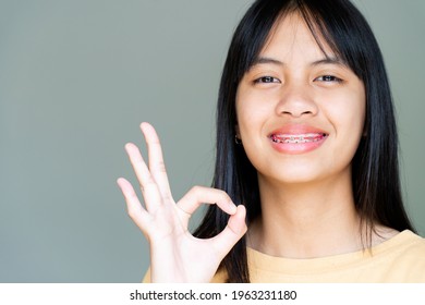 Dental Brace Girl Smiling And Looking To Camera, She Feel Happy And Have Good Attitude With Dentist.  Motivate Kids Not Fear When They Have To Go To Dental Clinic.