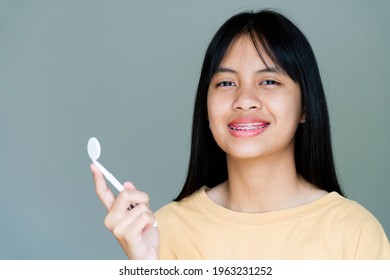 Dental Brace Girl Smiling And Looking To Camera, She Feel Happy And Have Good Attitude With Dentist.  Motivate Kids Not Fear When They Have To Go To Dental Clinic.