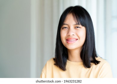 Dental Brace Girl Smiling And Looking To Camera, She Feel Happy And Have Good Attitude With Dentist.  Motivate Kids Not Fear When They Have To Go To Dental Clinic.