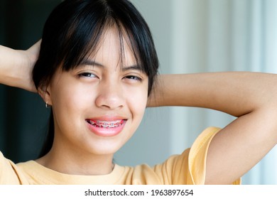 Dental Brace Girl Smiling And Looking To Camera, She Feel Happy And Have Good Attitude With Dentist.  Motivate Kids Not Fear When They Have To Go To Dental Clinic.