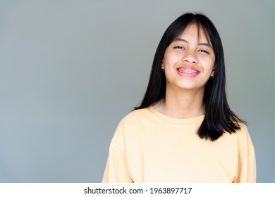 Dental Brace Girl Smiling And Looking To Camera, She Feel Happy And Have Good Attitude With Dentist.  Motivate Kids Not Fear When They Have To Go To Dental Clinic.