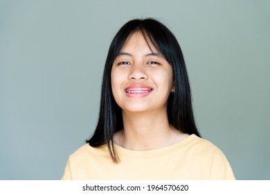 Dental Brace Girl Smiling And Looking To Camera, She Feel Happy And Have Good Attitude With Dentist.  Motivate Kids Not Fear When They Have To Go To Dental Clinic.