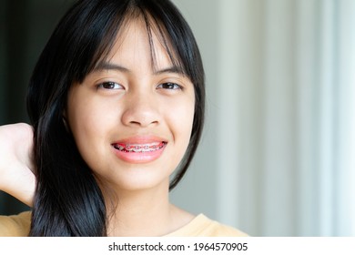 Dental Brace Girl Smiling And Looking To Camera, She Feel Happy And Have Good Attitude With Dentist.  Motivate Kids Not Fear When They Have To Go To Dental Clinic.